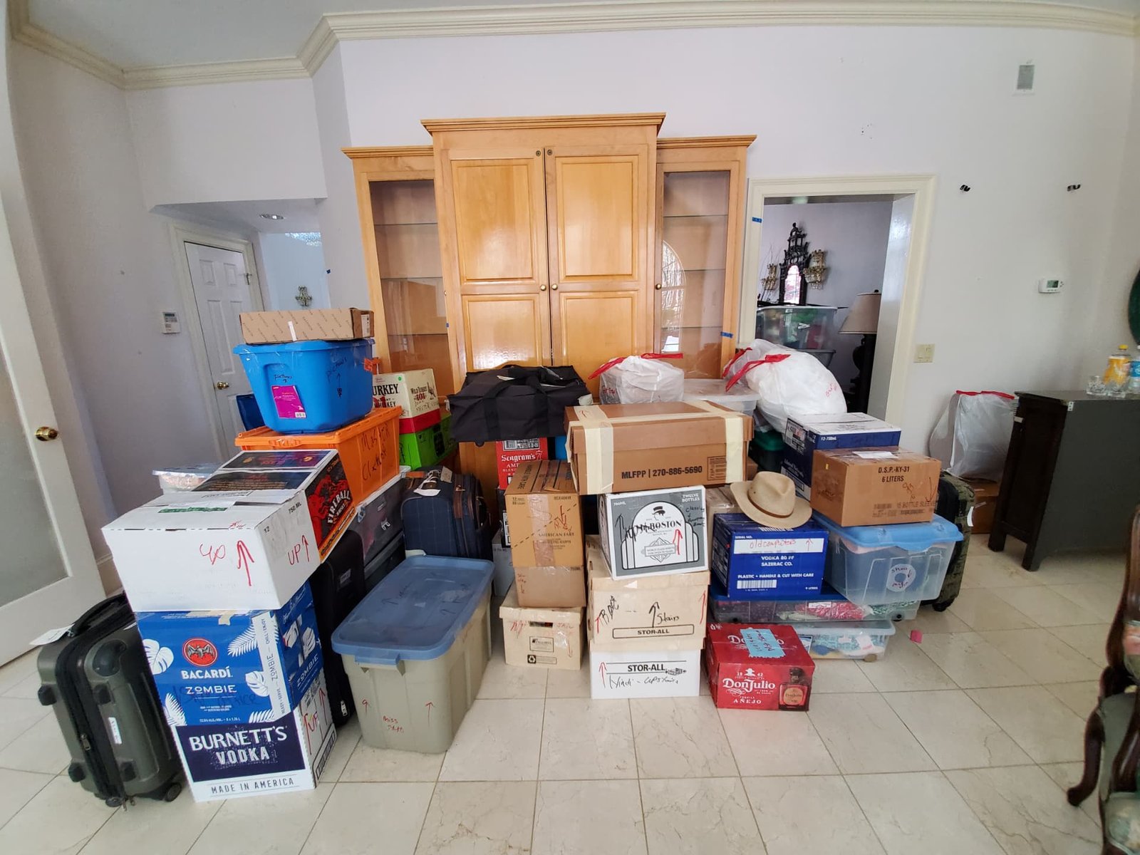 A living room with labeled boxes and bins sorted and staged for move day