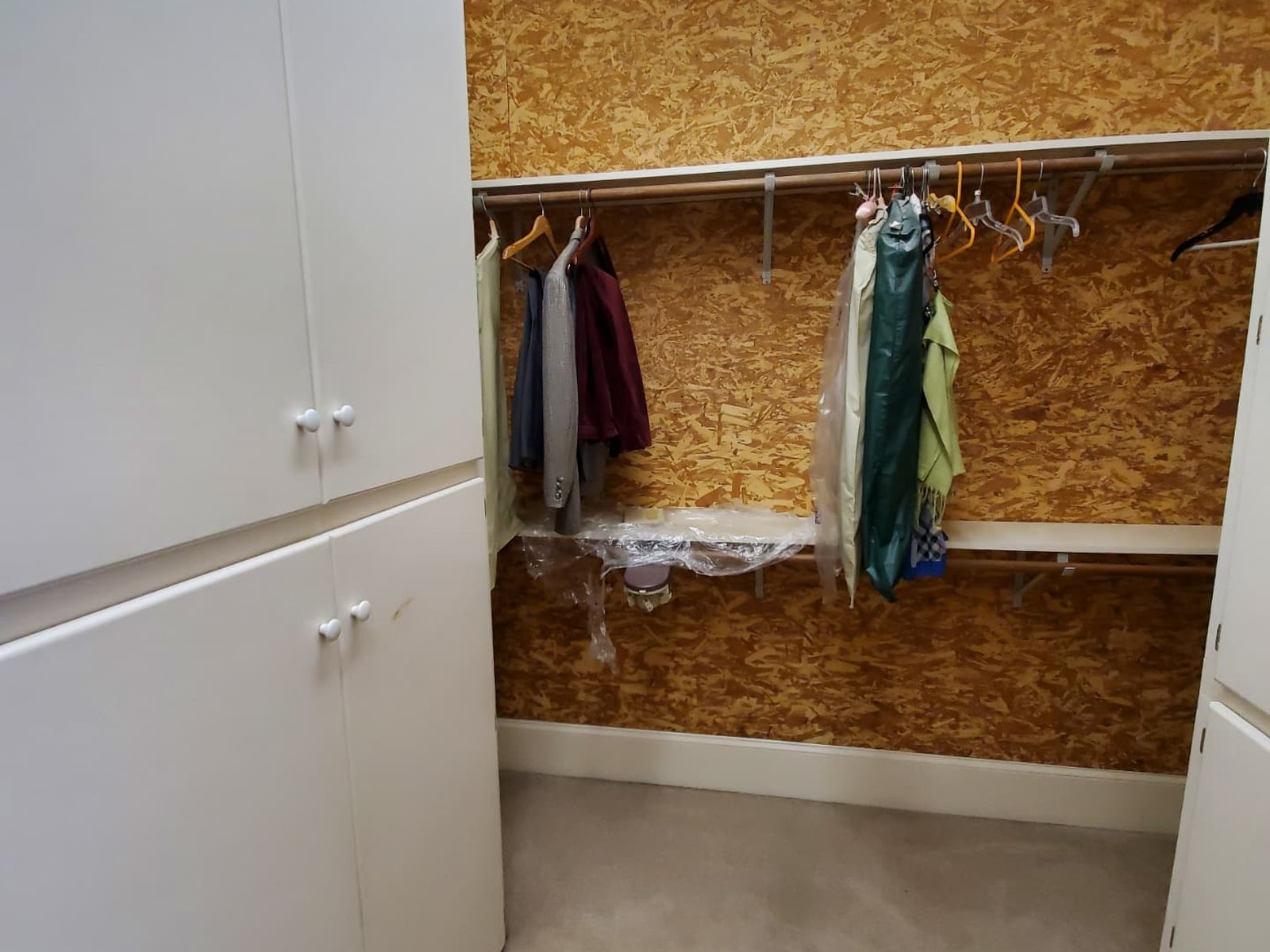 A closet arranged with clothing hung and ready in a new home